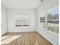 Bright bedroom with hardwood floors, large windows, and a closet door at 11857 Rizvan Pl, Covington, GA 30014