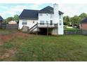 Large backyard featuring a deck, lawn, and bordering trees, providing a private outdoor space at 350 Glynnshire Ct, Covington, GA 30016