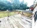 View of wood deck overlooking a fenced-in backyard with a basketball court at 350 Glynnshire Ct, Covington, GA 30016