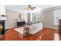 Cozy living room with hardwood floors, fireplace, and natural light at 7863 Kiverton Pl, Atlanta, GA 30350