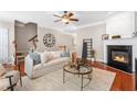 Bright living room with hardwood floors, a fireplace, and neutral decor at 7863 Kiverton Pl, Atlanta, GA 30350