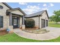 Welcoming brick home featuring a two-car garage, manicured landscaping, and a secure ADT security system at 80 Pulaski Pl, Jonesboro, GA 30238