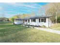 Angle view of painted white single-story house with a well maintained lawn at 144 Morning Creek Rd, Jonesboro, GA 30238