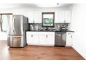 Modern kitchen with stainless steel appliances, white cabinets, and contrasting countertops at 144 Morning Creek Rd, Jonesboro, GA 30238