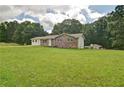 Spacious yard with a well-maintained home featuring both brick and vinyl siding at 24 Echo Ridge Dr, Powder Springs, GA 30127