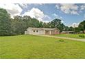 Well-maintained home featuring a large yard, mature trees, and a bright exterior at 24 Echo Ridge Dr, Powder Springs, GA 30127
