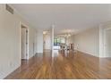 Spacious living room with gleaming hardwood floors leading to dining area and a view of trees outside at 3530 Piedmont Ne Rd # K8, Atlanta, GA 30305