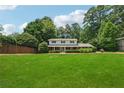 Charming two-story home features a well-manicured lawn, and mature trees at 4984 Wickford Way, Atlanta, GA 30338