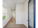 Bright hallway featuring wood-look floors and fresh, neutral paint at 11847 Rizvan Pl, Covington, GA 30014