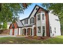 Beautiful two-story house with a brick and siding exterior, landscaped yard at 160 Magnolia Walk Ln, South Fulton, GA 30349