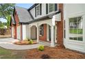 Close-up of front entrance showing covered porch and manicured landscaping at 160 Magnolia Walk Ln, South Fulton, GA 30349