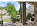 Charming front porch view with stone flooring and serene neighborhood setting at 1701 Tipton Nw Ct, Acworth, GA 30101