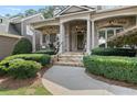 Inviting front porch with stone walkway, columns, and lush landscaping at 1701 Tipton Nw Ct, Acworth, GA 30101