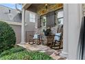 Relaxing front porch featuring rocking chairs, a side table, and manicured shrubbery at 1701 Tipton Nw Ct, Acworth, GA 30101