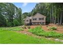 Inviting two-story home with manicured lawn and lush green surroundings at 400 Hunt River Way, Suwanee, GA 30024
