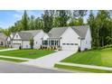 Beautiful home showcasing lush green grass, a long driveway, and an attached two-car garage at 51 Black Rock Rdg, Sharpsburg, GA 30277
