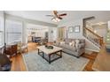 Open concept living room with hardwood floors seamlessly flows to dining area and kitchen at 2508 Haddenham Sw Ln, Smyrna, GA 30082