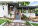 Inviting entrance to a charming home featuring a modern handrail and covered porch at 1261 Calhoun Sw Ter, Atlanta, GA 30314