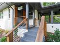 Inviting entrance to a charming home featuring a modern handrail and covered porch at 1261 Calhoun Sw Ter, Atlanta, GA 30314