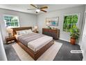 Cozy, virtually staged bedroom with ample natural light, a ceiling fan, and stylish furnishings at 540 Stockwood Dr, Woodstock, GA 30188