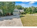 Inviting home with a spacious front yard, basketball hoop, and outdoor firepit perfect for Gathering gatherings at 127 Muirwood Dr, Temple, GA 30179