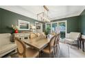 Elegant dining room featuring modern lighting, neutral chairs, and a large window at 177 Coopers Pond Dr, Lawrenceville, GA 30044