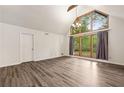 Bright living room with hardwood floors, white walls, and a large window offering great views at 1832 Tree Top Ct, Marietta, GA 30062