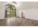 Bright living room with hardwood floors, white walls, and a large window at 1832 Tree Top Ct, Marietta, GA 30062