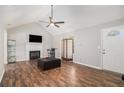 Bright living room boasts a fireplace, wood floors, and vaulted ceilings at 28 Fawn Ct, Sharpsburg, GA 30277