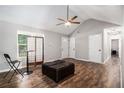 Spacious living room with wood floors, a ceiling fan, and ample natural light at 28 Fawn Ct, Sharpsburg, GA 30277