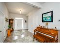 Bright and airy foyer with hardwood floors, a grandfather clock, and a grand piano at 4380 Serenity Lake Dr, Cumming, GA 30028