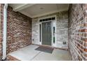Inviting covered entryway features a stylish front door with stone and brick accents at 4380 Serenity Lake Dr, Cumming, GA 30028