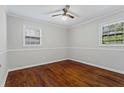 Bright bedroom with hardwood floors, ceiling fan, and two windows offering natural light at 4090 Tara Dr, Forest Park, GA 30297
