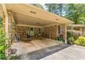 Attached carport with brick columns and light green doors at 5400 Francis Ave, Stone Mountain, GA 30087