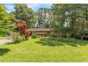 Lovely home with a lush green lawn and colorful landscaping, offering a welcoming outdoor space at 5400 Francis Ave, Stone Mountain, GA 30087