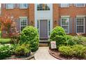 Close-up of an inviting front entrance, featuring a brick facade and professionally landscaped garden at 5003 Pacific Dunes Dr, Suwanee, GA 30024