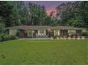 Charming brick home with manicured lawn and inviting front porch seating at 1620 Stonecliff Dr, Decatur, GA 30033