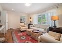 Comfortable living room featuring hardwood floors, a plush sofa, and bright windows at 1620 Stonecliff Dr, Decatur, GA 30033