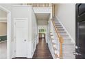 Bright foyer featuring hardwood floors, a staircase with white railings, and neutral wall paint at 2268 Orleans Ave, Marietta, GA 30062