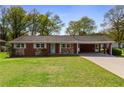 Inviting single-Gathering home showcasing a lush green lawn and covered parking at 3031 Walker Dr, Marietta, GA 30062