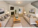 Staged living room with fireplace, light colored sofas and walls creating an inviting and comfortable ambiance at 6240 Shenfield Ln, Union City, GA 30291