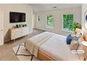 Bright main bedroom with large windows, dresser, and neutral tones, offering a serene retreat at 6240 Shenfield Ln, Union City, GA 30291