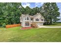 Charming split-level home featuring stone accents, wood shutters, and a two-car garage at 121 Paradise Circle, Douglasville, GA 30134