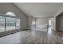 Spacious living room boasting cathedral ceilings, large windows, and modern gray flooring at 121 Paradise Circle, Douglasville, GA 30134
