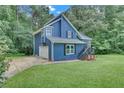 Beautiful two-story home featuring blue siding, a well-manicured lawn, and an attached garage at 3706 Londonderry Ct, Lithonia, GA 30038