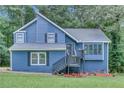 Charming two-story home with blue siding, landscaped front yard, and inviting front porch at 3706 Londonderry Ct, Lithonia, GA 30038