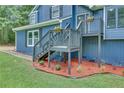 Inviting front porch with steps, gray trim, and decorative flower planters, adding curb appeal at 3706 Londonderry Ct, Lithonia, GA 30038