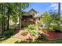 Exterior view of home highlighting screened porch, landscaped backyard, and multi-level deck at 2214 Trilleck Nw Dr, Kennesaw, GA 30152