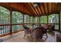 Relaxing screened porch featuring wood ceiling, comfortable seating, and a picturesque view at 2214 Trilleck Nw Dr, Kennesaw, GA 30152