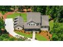 Expansive aerial view of a two-story home with a manicured lawn and a long driveway at 313 Anderwood Rdg, Marietta, GA 30064